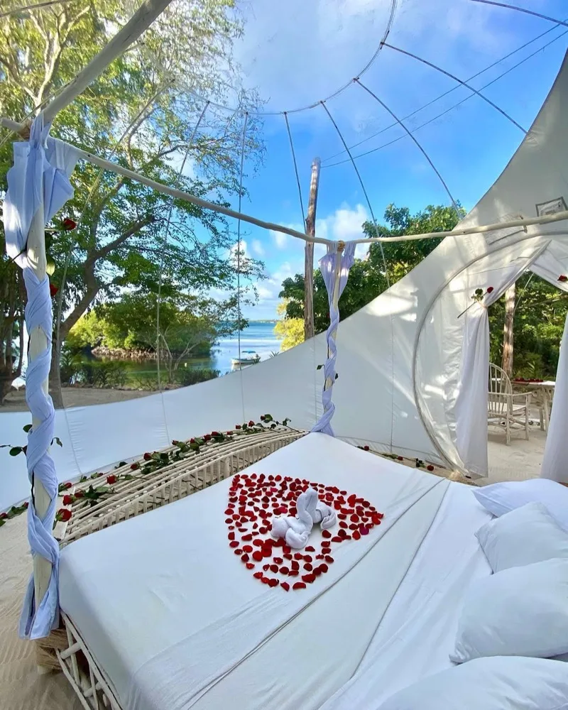 King bed on soft white sand