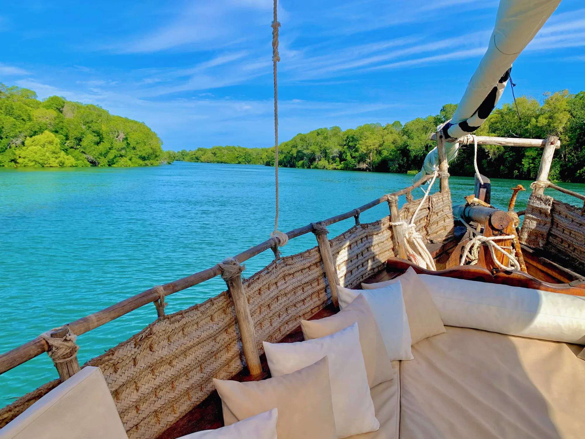 The traditional wooden dhow Pepo Huru sailing across the turquoise waters of Mida Creek
